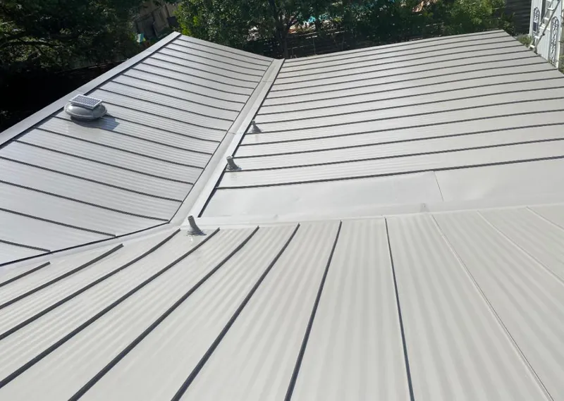 Solar attic fan installed on a metal roof for Roof Ventilation in Fergus Falls